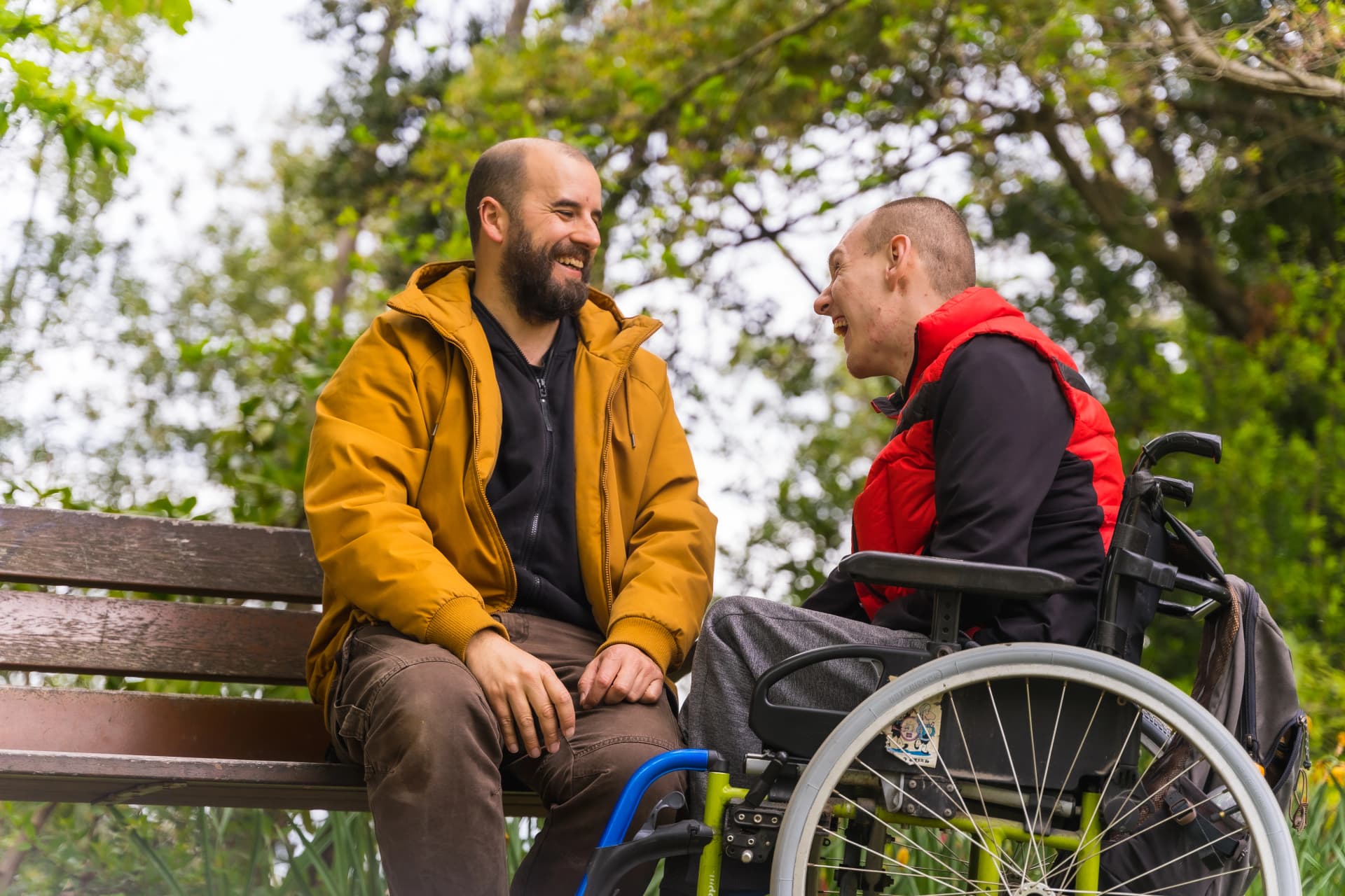 Friends with wheelchair enjoying time together in the park